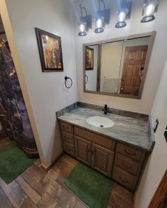 camo bathroom with camo shower curtain and green bathmats