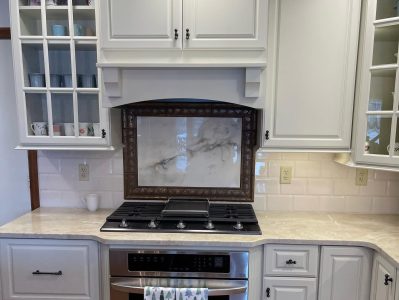 kitchen stove design with fancy framed marble backsplash