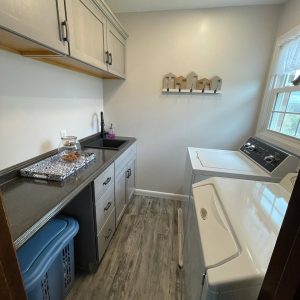 laundry room with cabinets and sink