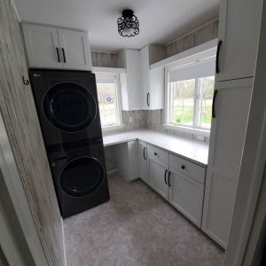 laundry room cabinets and stacked washer dryer