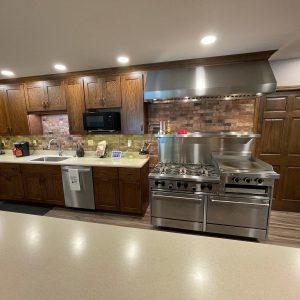 professional stove with gas burners and steel flattop