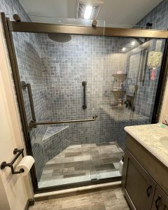 walk in shower with seating and glass door